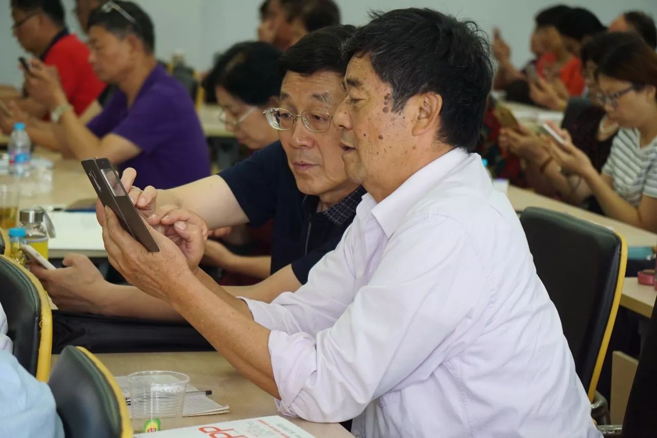 pic2_两位老人正在“老小孩”的课堂上学习如何使用微信.jpg